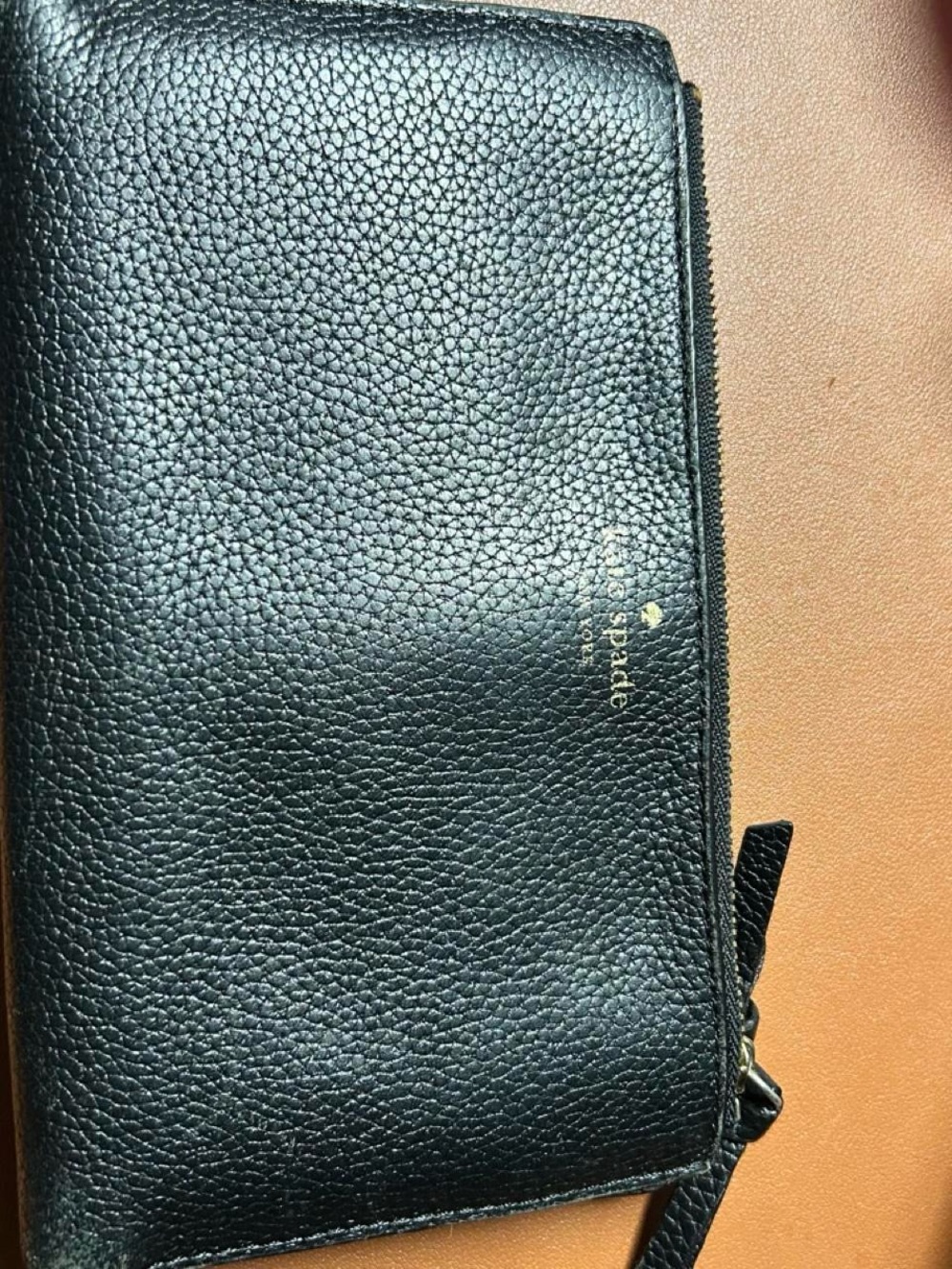 kate spade black pebbled leather wristlet with gold logo